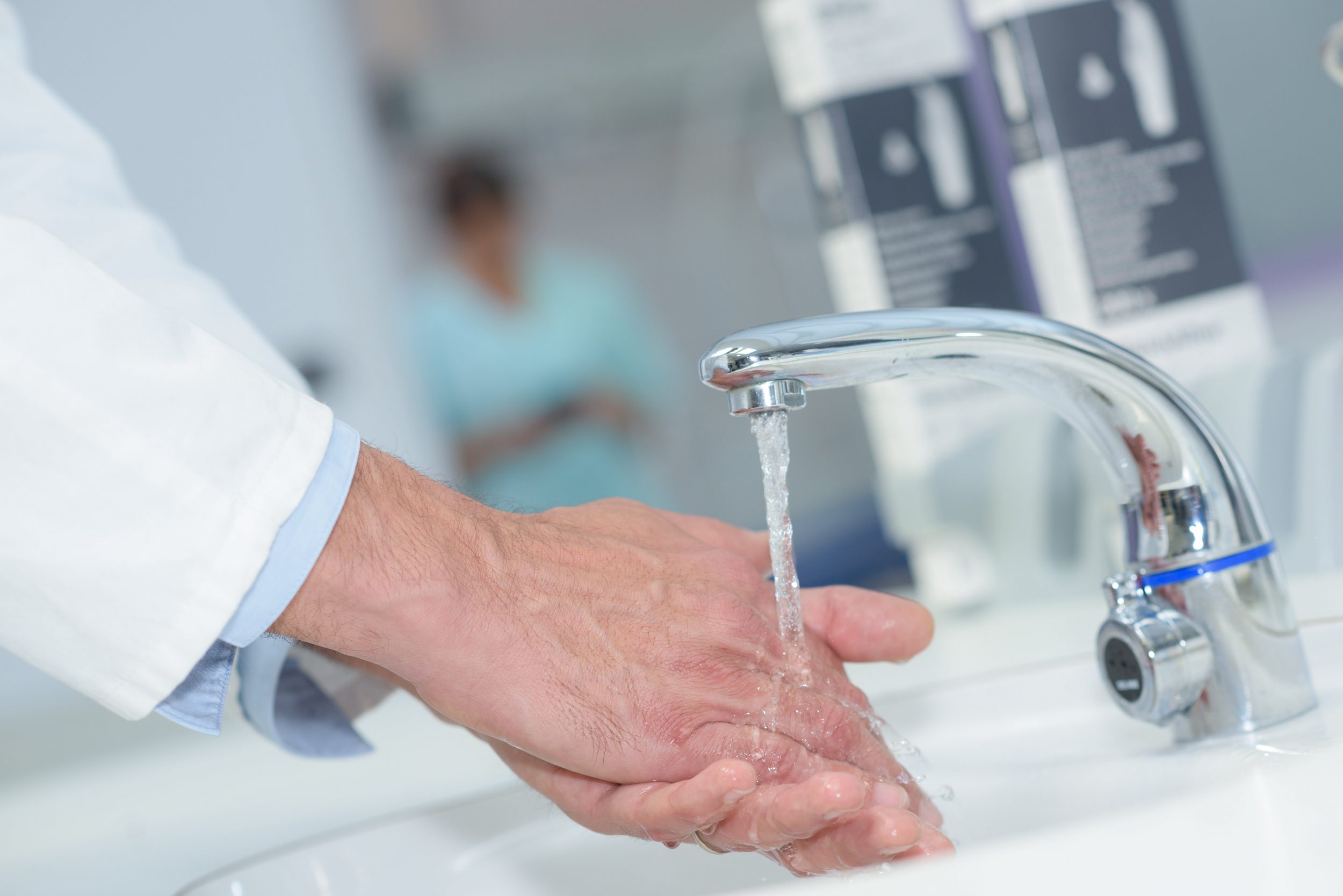 Total Water Solutions. Doctor washing hands in sink