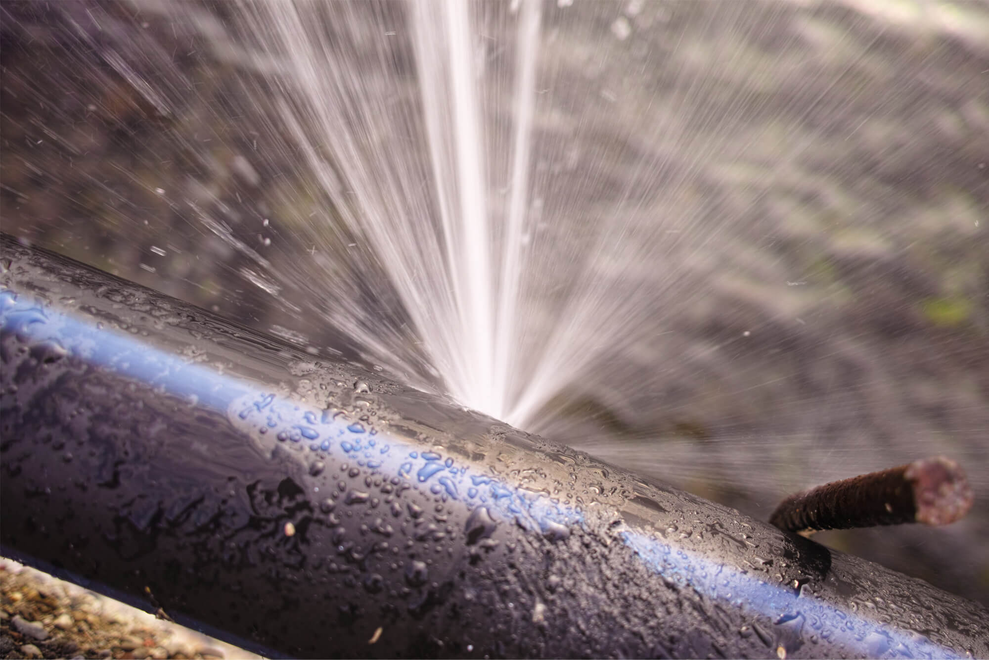 Metal pipe with a burst, spraying water