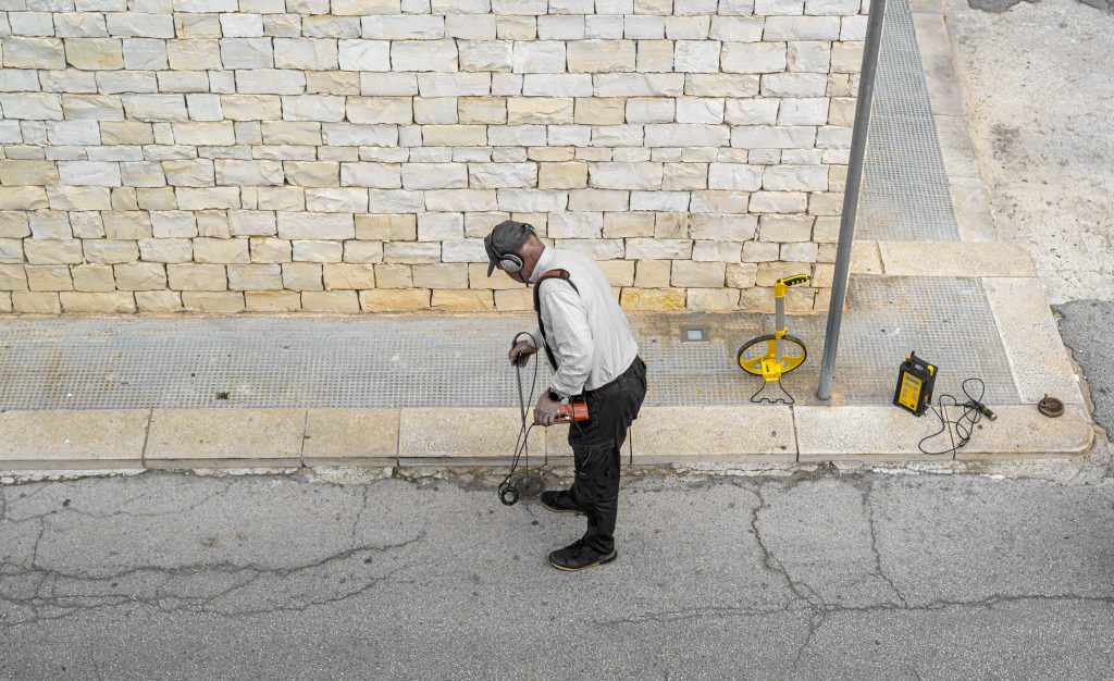 Man filling cracks in the road